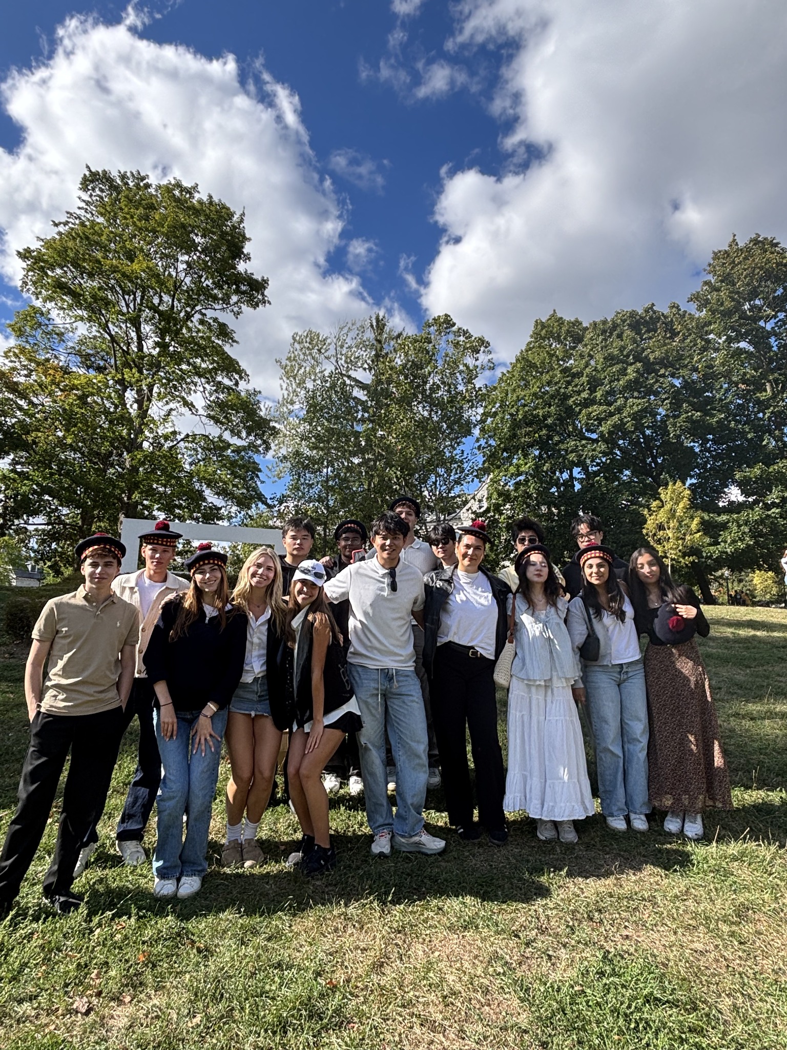 A student orientation group outdoors under a bright sky